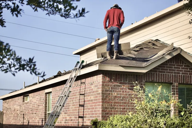 Professional roofer working on a residential roof in Bayonne